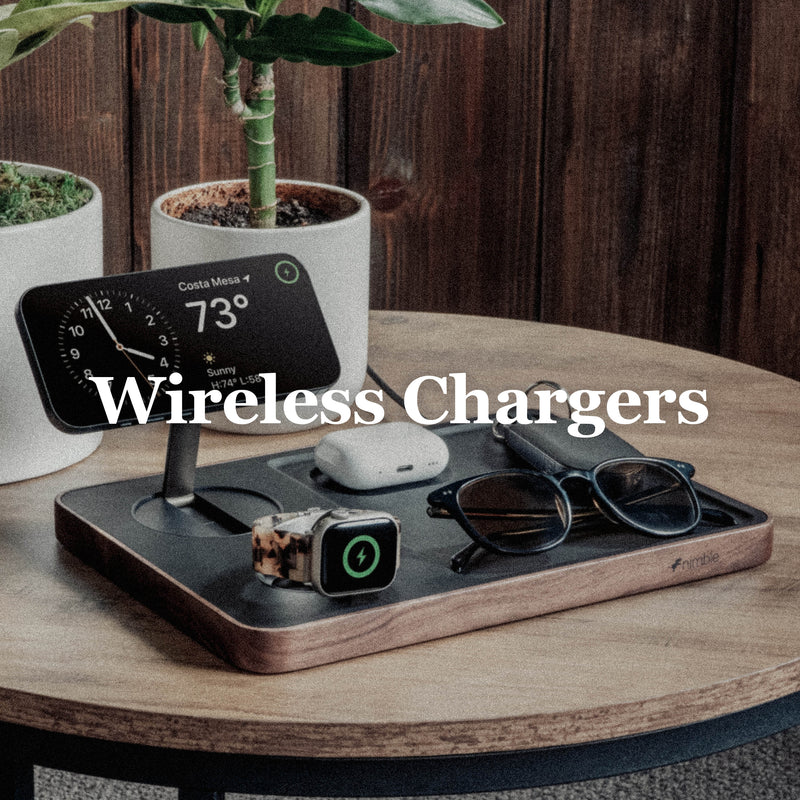 Image of Valet 3-in-1 Wirelss Charger with iPhone, AirPods, Apple Watch charging and Glasses, keys placed as well. All is on small wood table with potted bamboo plants and wood wall. Wireless Chargers text overlay.